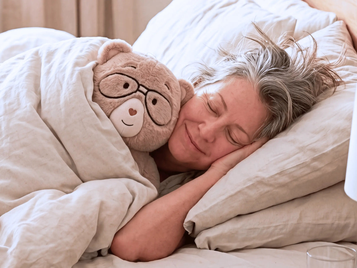Person sleeping with Percy bear 
