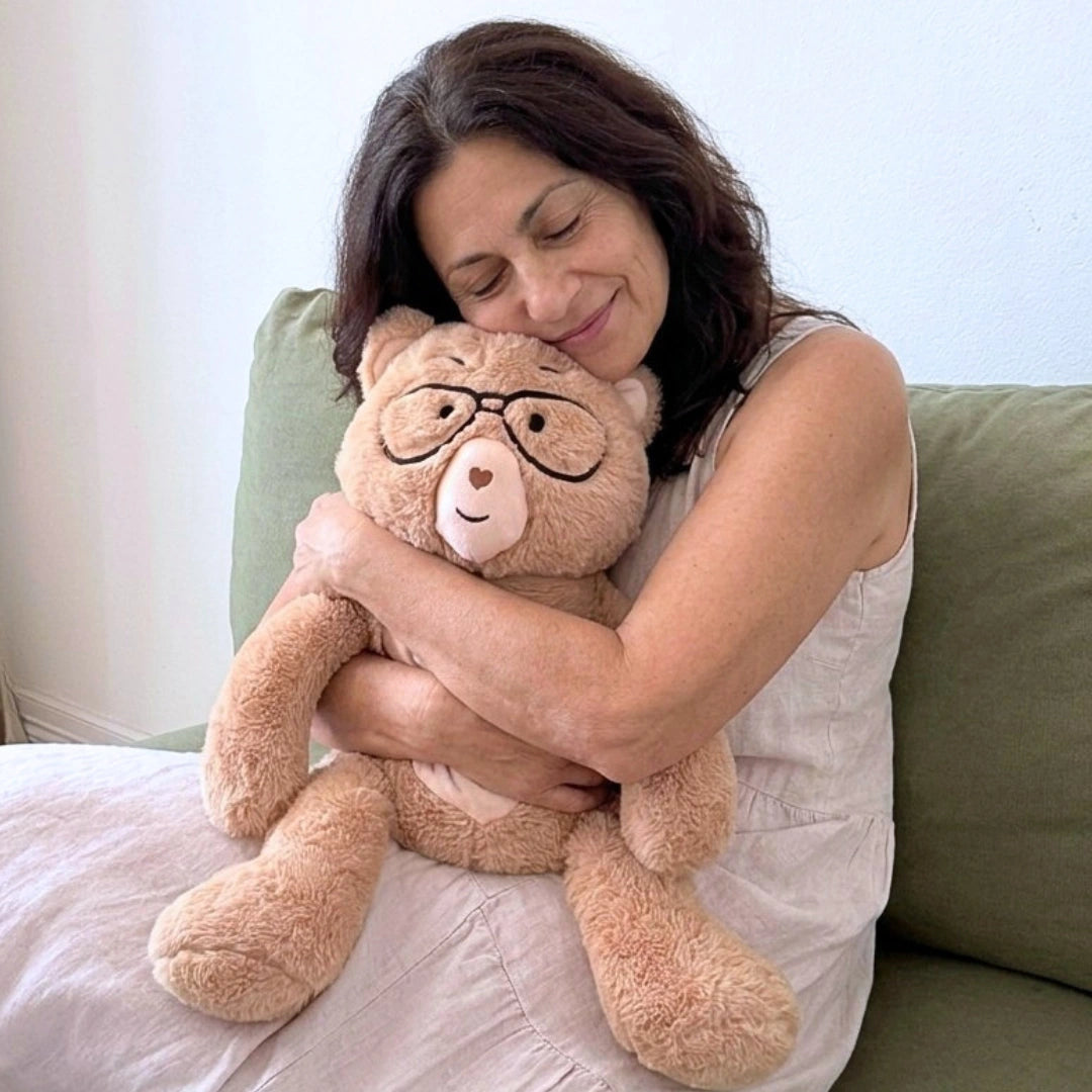 Woman hugging Percy bear on a couch