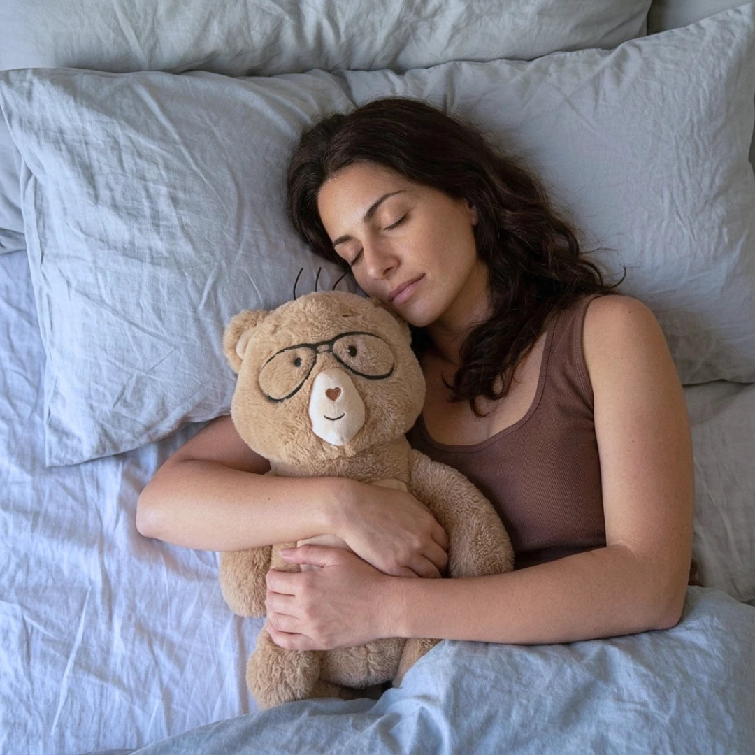 woman laying on bed napping with Percy the bear