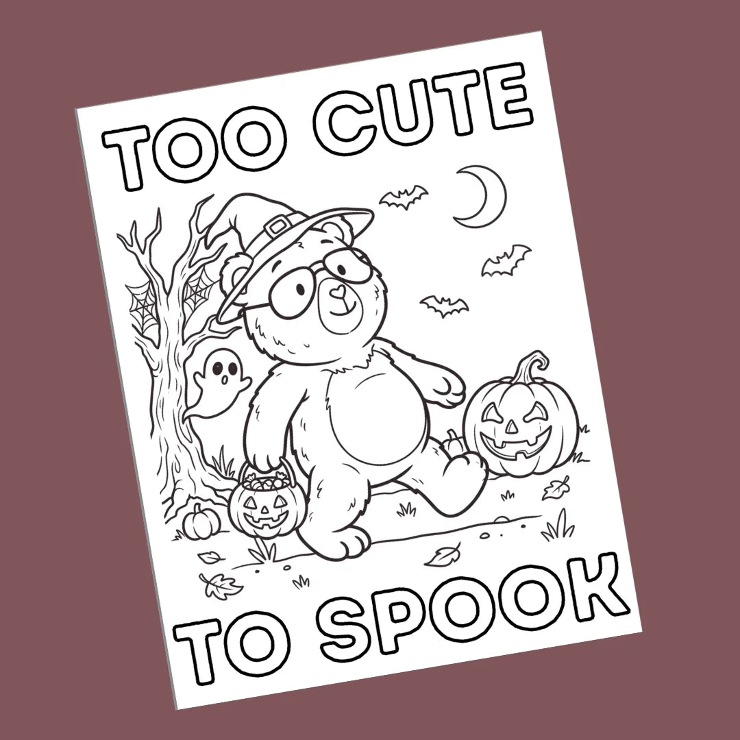A black and white cartoon bear coloring page with Halloween illustrations, shown at an angle against a solid dark mauve background. The text reads 'TOO CUTE TO SPOOK'.