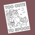 A black and white cartoon bear coloring page with Halloween illustrations, shown at an angle against a solid dark mauve background. The text reads 'TOO CUTE TO SPOOK'.